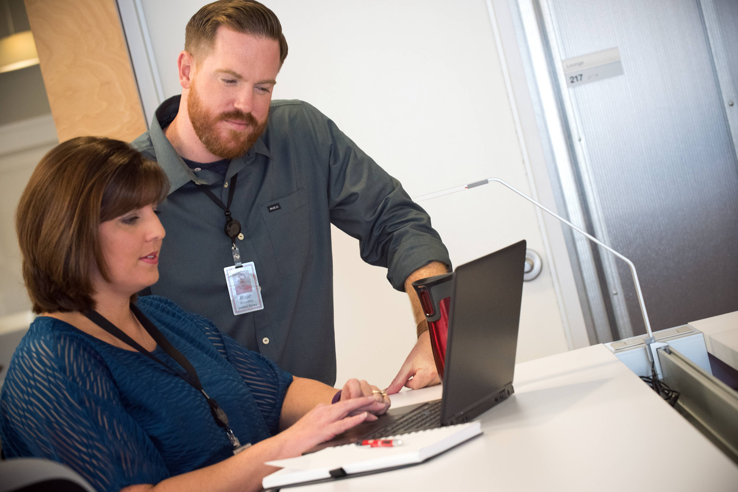 Two associates looking at a computer