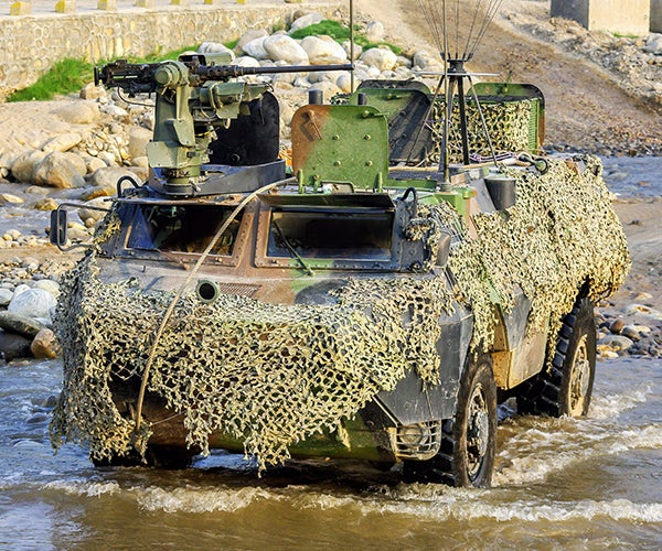 Camouflaged Armored Tank in a River