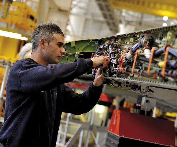 Image of a technician performing aircraft maintenance.