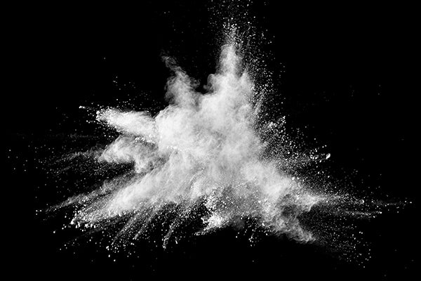 White powder explosion on black background.