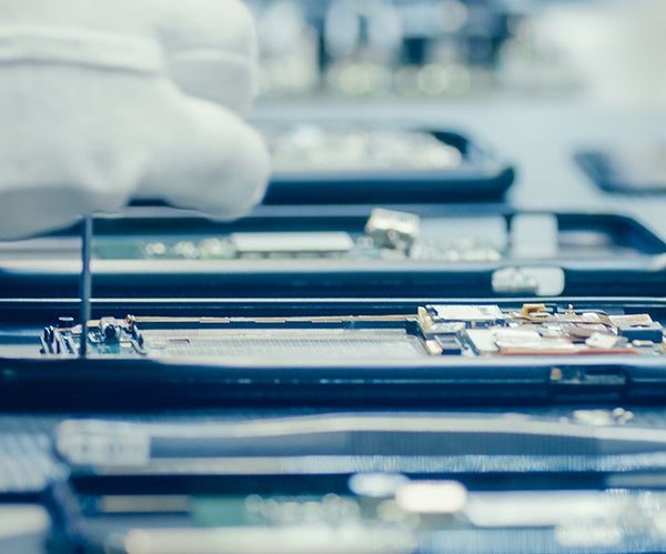 Image of technician working in a smartphone.