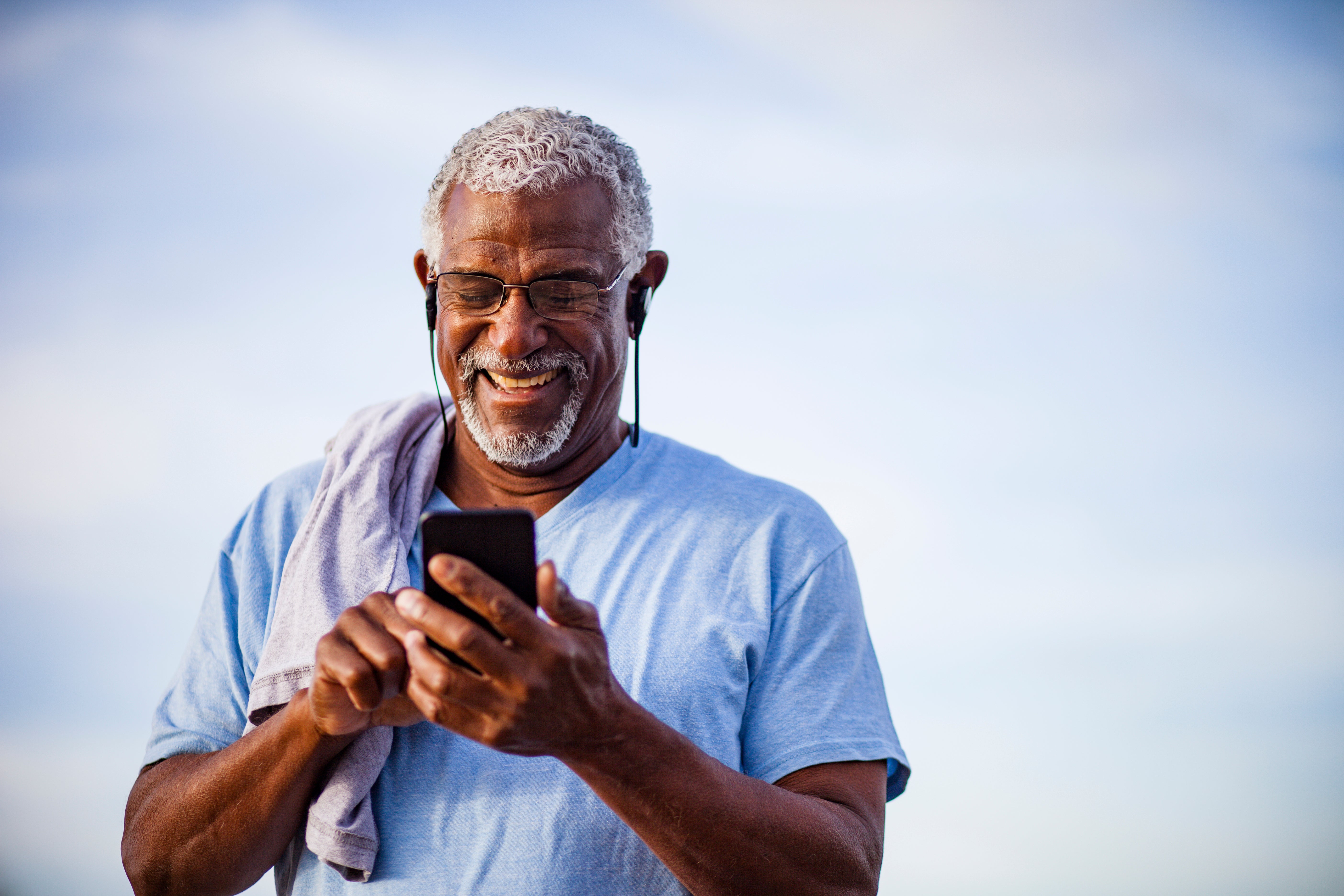 Man using phone and smiling