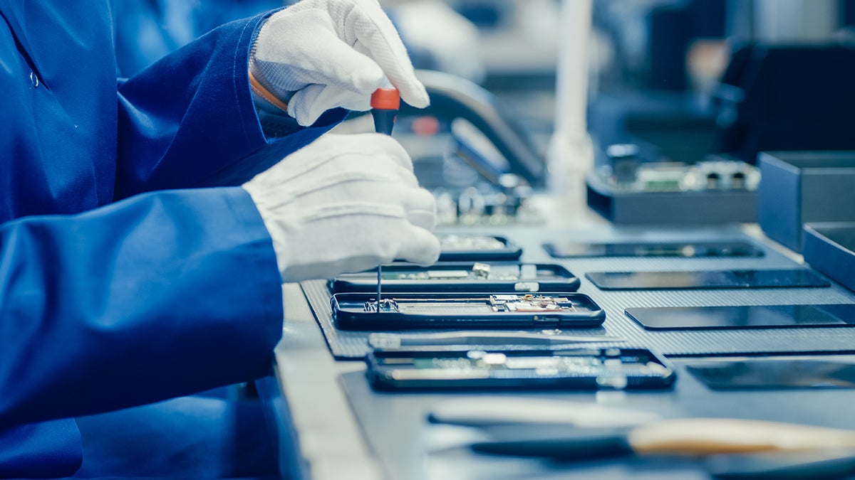 hands repairing a smartphone