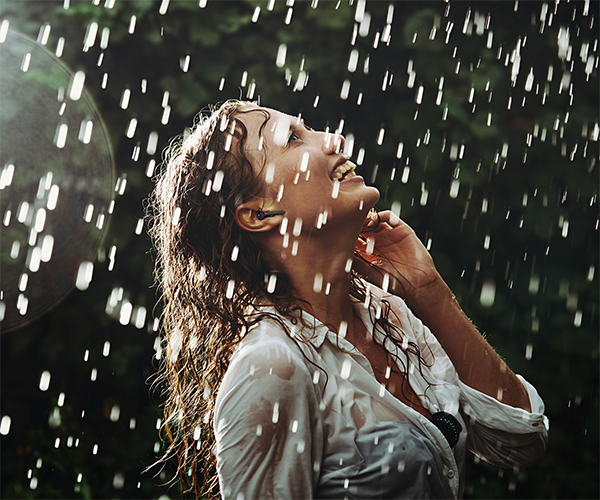 Woman with earbuds in the rain