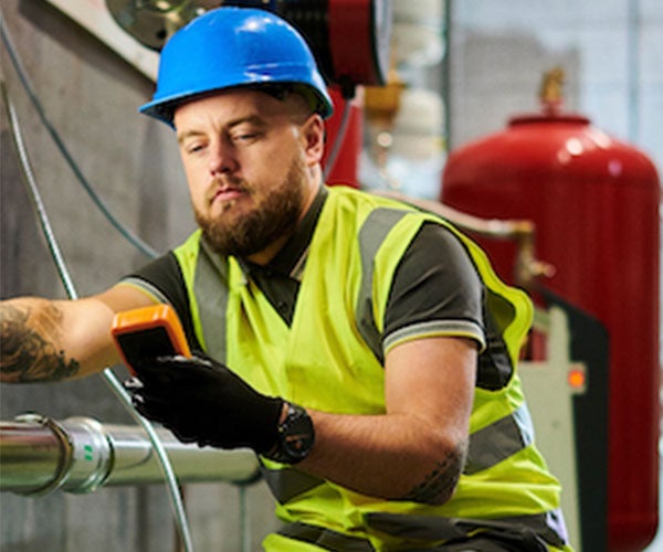Construction worker looking at digital device