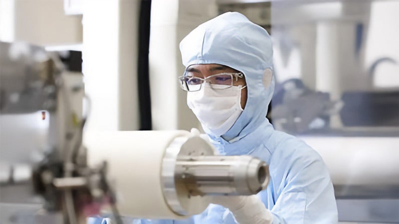 Clean Energy technician operating a machine while wearing PPE.