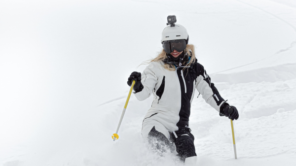woman skiing with camera mounted to her helmet