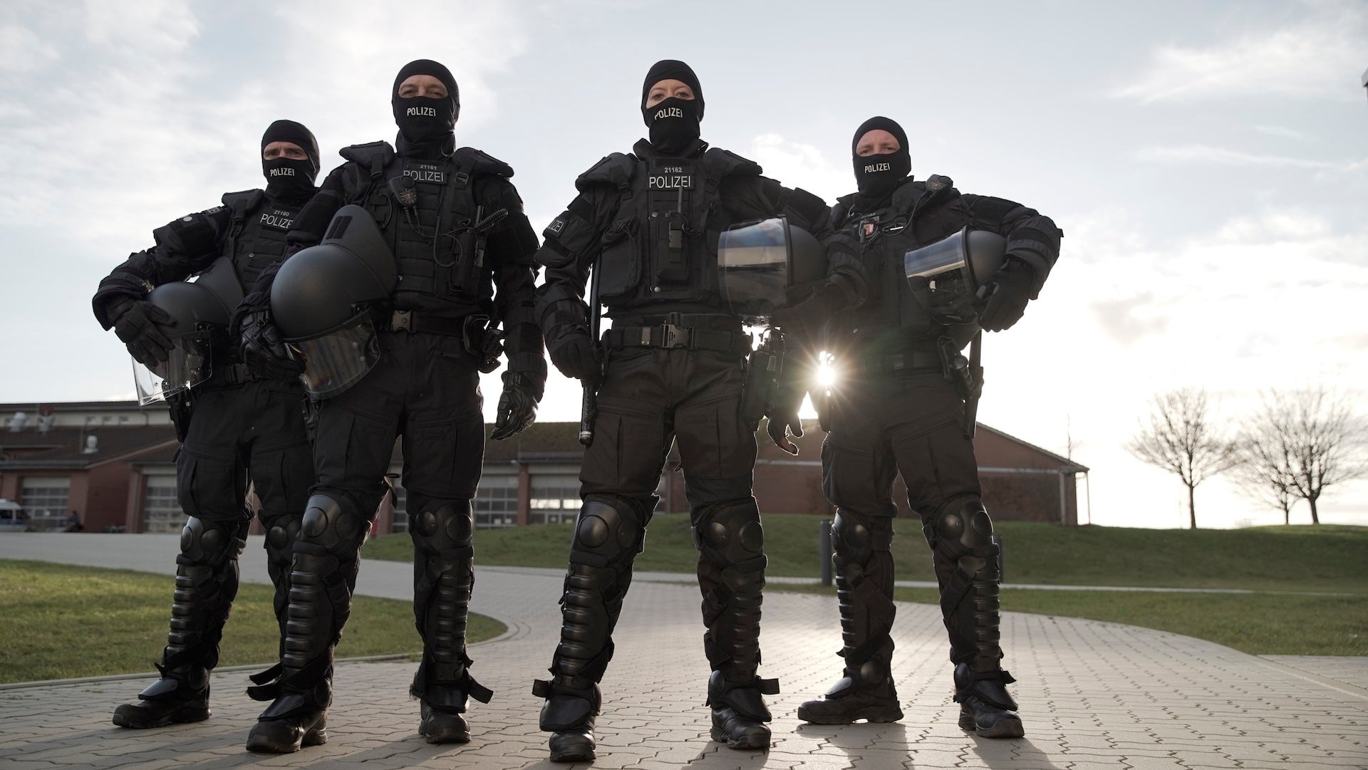 group of swat police officers standing in their gear