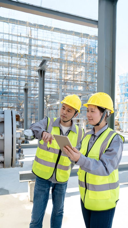 Workers wearing PPE performing test on a specialized pipe.