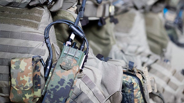 Behind shot of Military gear including a uniform and communication system.