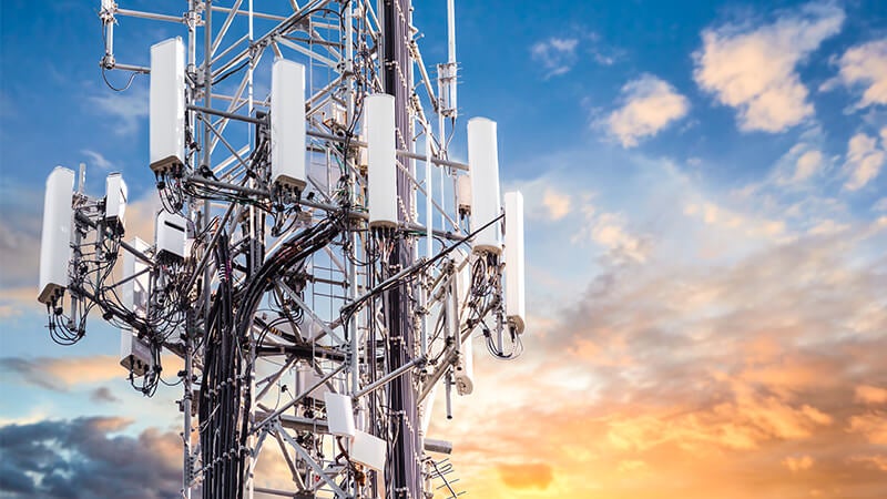 Telecommunications tower over sunset