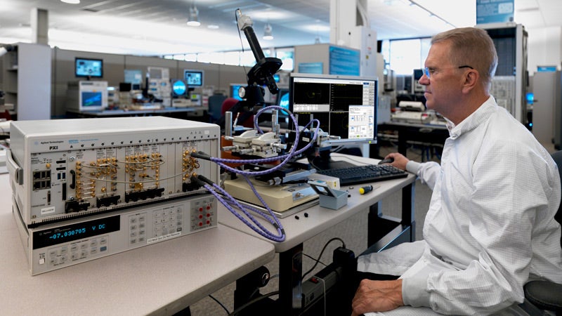A technician from Keysight Technologies running some tests on specialized machine.