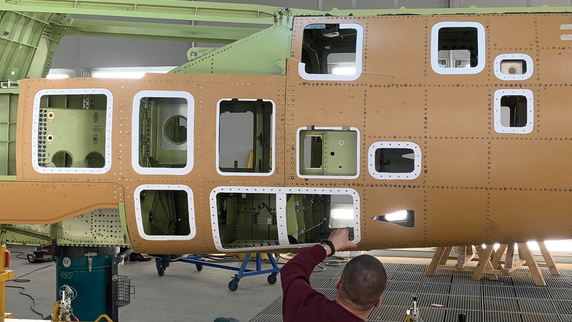 Man working on 700 Series M 345 Trainer Fuselage Panel