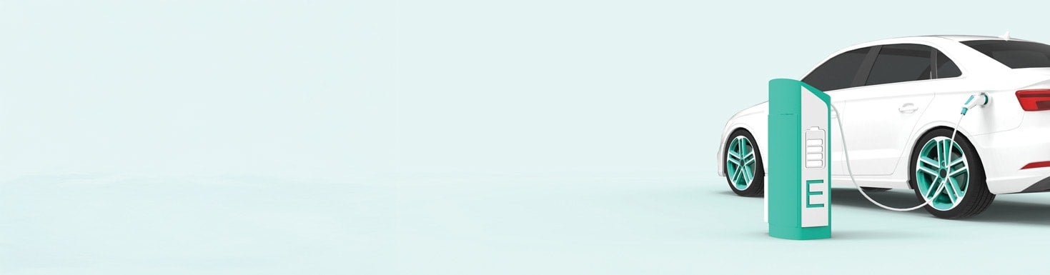 Electric Vehicle charging in front of a light blue backdrop