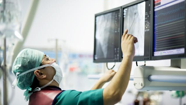 doctor reviewing a screen in the operating room
