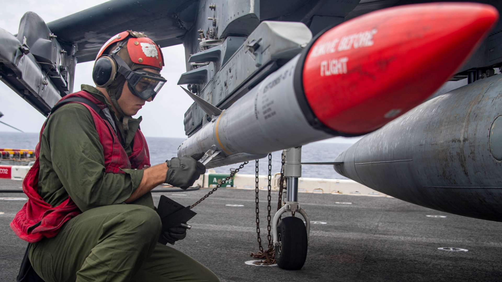Technician loading AMRAAM missile on aircraft