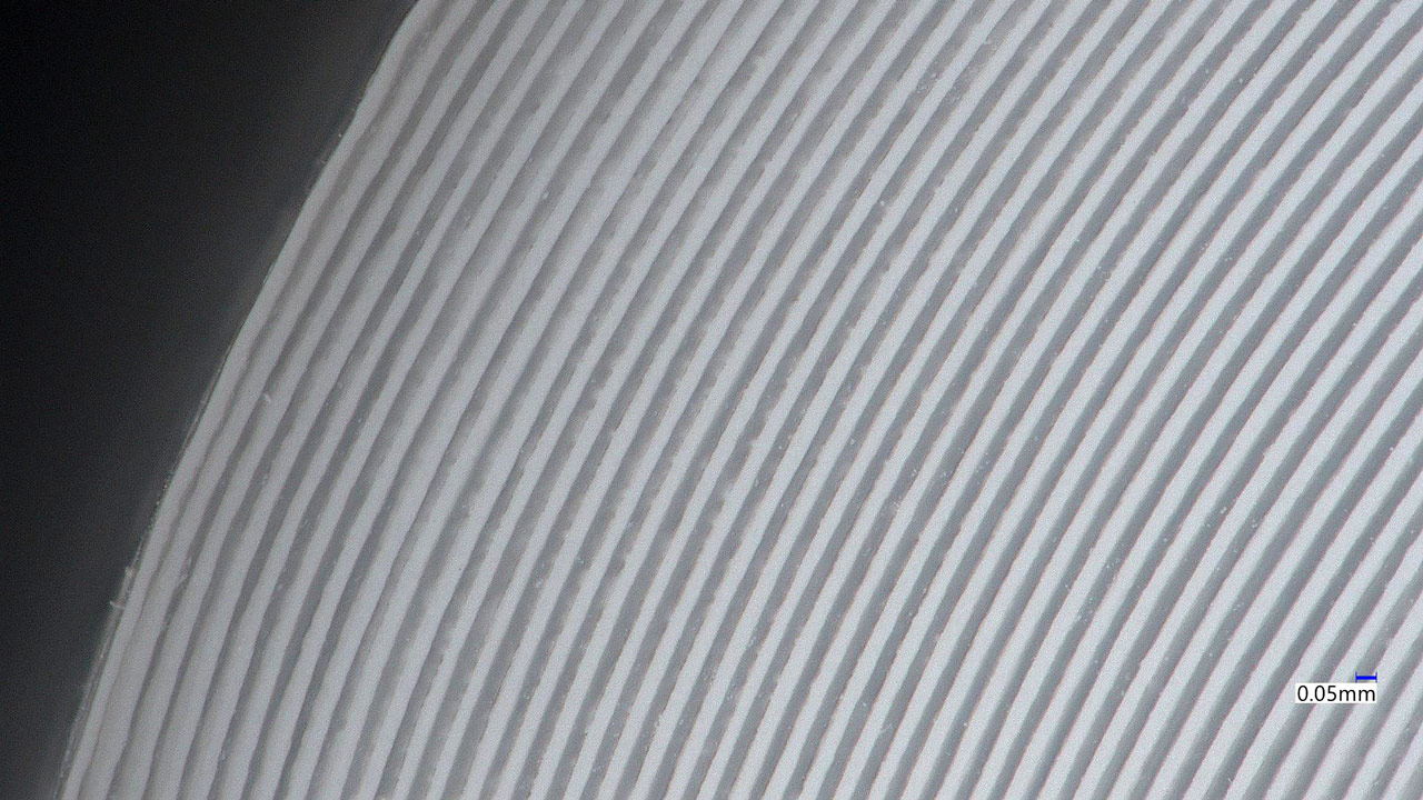 Close-up of tubing cross-section showing layered internal structure and material texture
