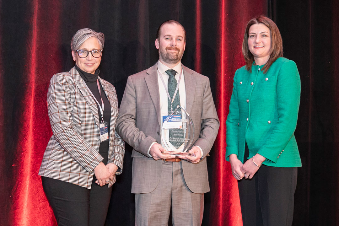 Gore associates stand on stage accepting a supplier award from BAE Systems.