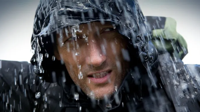 Man wearing a raincoat while it's raining