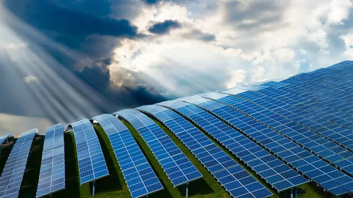 Sun shining on a field with rows of Solar Panels.