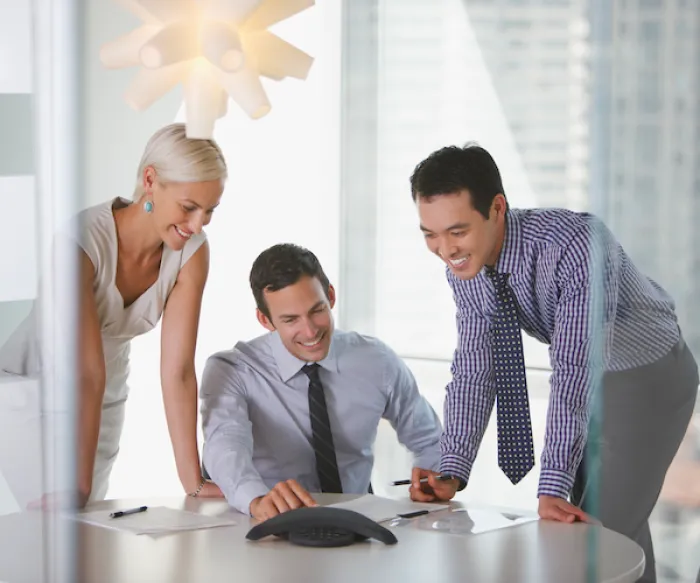 coworkers in conference room reviewing papers