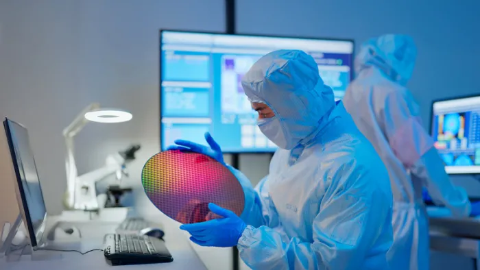 Worker examining a wafer electronic disc