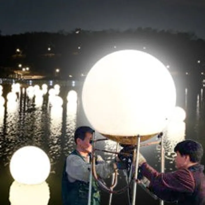 Waterborne Moon Lights being set up near the water