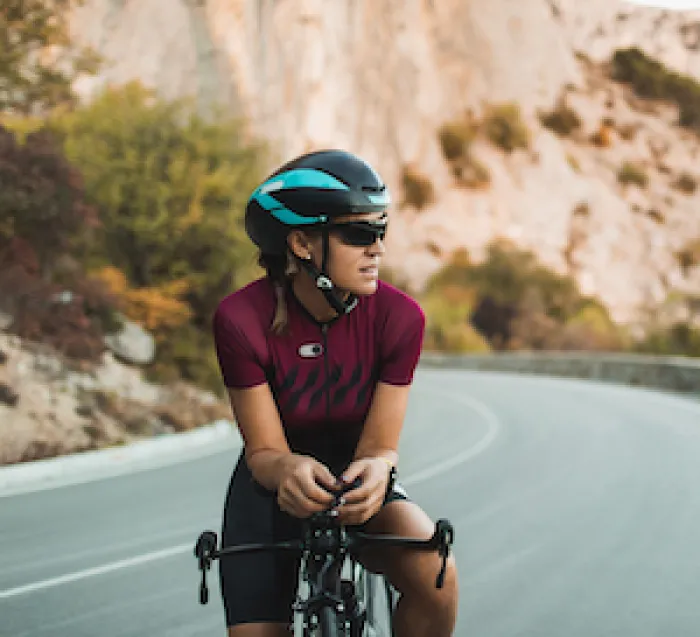 Female cyclist stopping on road