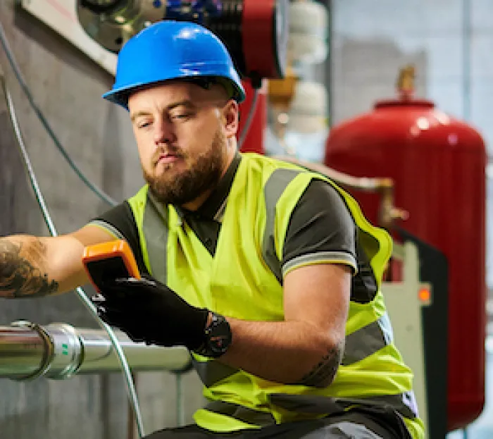 male worker reading mobile device
