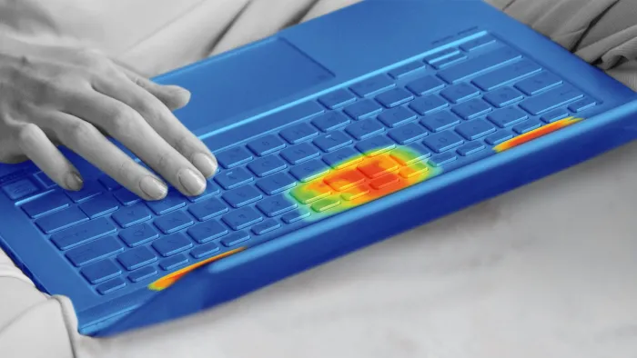 A monochrome photo of a person using a laptop