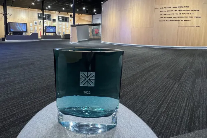 photo of 2022 World Class Briefing Center award with capabilities center in the background