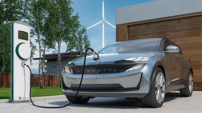 electric car SUV charging at home in front of modern suburban house