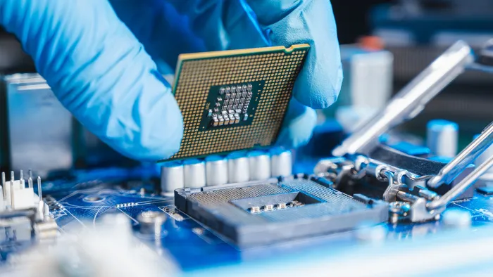 Lab technician working on circuit board
