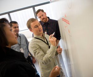 Associates collaborating at a whiteboard