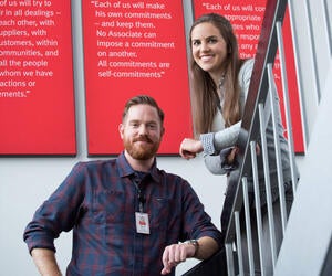 Two associates standing in a stairwell