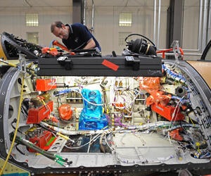 Military aircraft maintainer installing microwave able assemblies.