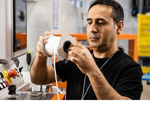 An Associate reviewing a product during the production process.