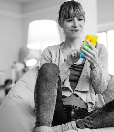 Woman sitting in chair looking at smart phone