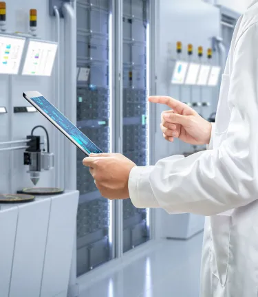 Laboratory technician holding tablet in cleanroom