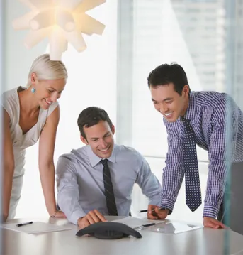 Three colleagues having a discussion in an office.