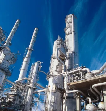 An industrial factory under a blue sky.