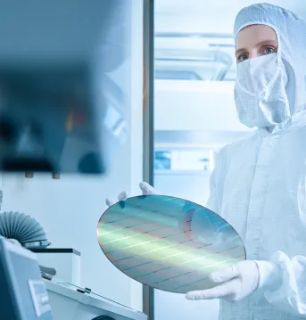 Engineer holding wafer chip in laboratory