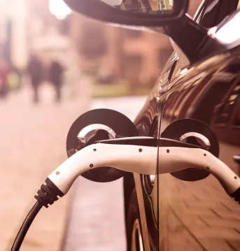 Electric Vehicle is charging in street.