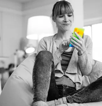 Woman sitting in chair looking at smart phone