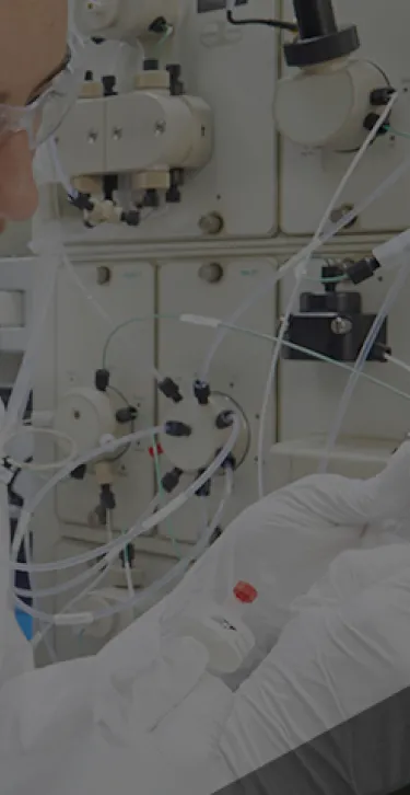 Professionals examining a laboratory machine.