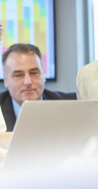 doctors in an office reviewing something on a computer