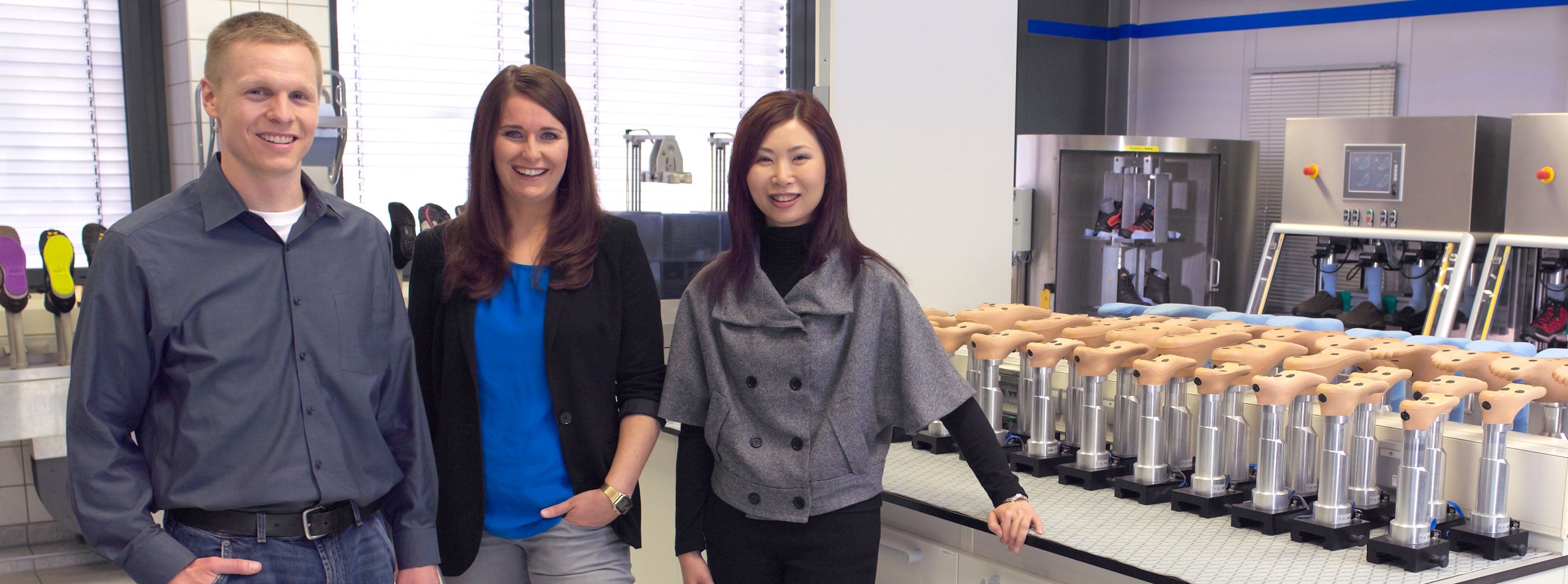 Three Associates standing in a footwear lab