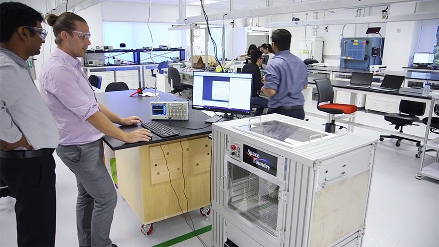 Associates collaborating in a lab space